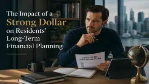 Premium editorial-style image about the impact of a strong U.S. dollar on long-term financial planning, featuring a professional man reviewing financial documents in a modern office with a city skyline background, cinematic lighting, and elegant typography reading “The Impact of a Strong Dollar on Residents’ Long-Term Financial Planning”.